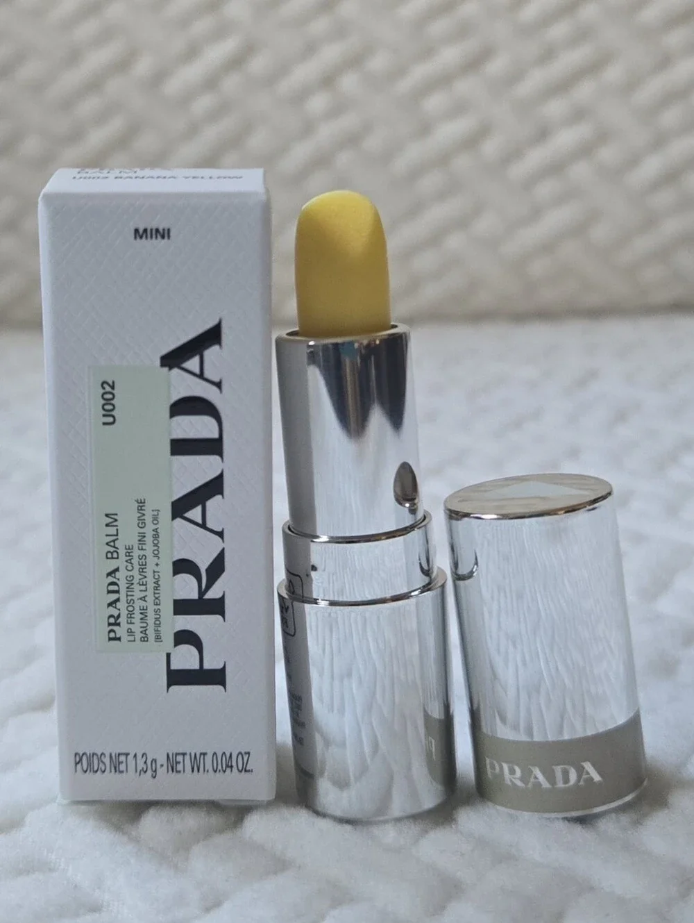 5/$25 or Free Gift: Prada Hydrating Lip Banana Balm with Jojoba Oil